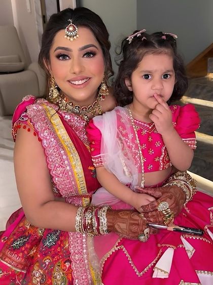 A beautiful rose pink glam look for a Mata Ki Chowki event. The vibrant makeup perfectly complements the colorful outfit and is suitable for both day and evening.