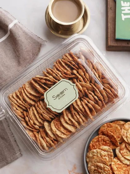 Craving something crunchy? My mini Chorafali Puris are just what you need. This image shows them packed in a clear box, ready to be paired with your evening tea.