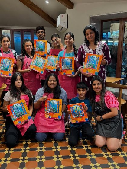 A family enjoying a painting workshop together at a cafe. Art is a wonderful activity that bridges generations and brings people closer.