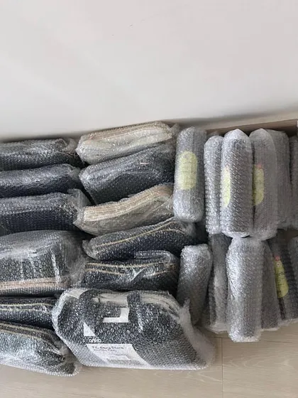 All the items carefully wrapped in bubble wrap, ready to be shipped out to my customers. I make sure everything is packed securely.