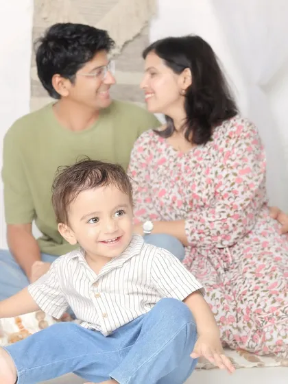 A candid moment of love between parents, while their little one takes center stage. This shows the mix of posed and lifestyle photography I love to do.