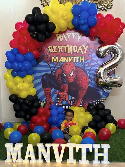 A vibrant and action-packed Spiderman theme for a second birthday. The setup features a dynamic backdrop, character cutouts, and a colorful balloon garland that perfectly captures the superhero's energy.