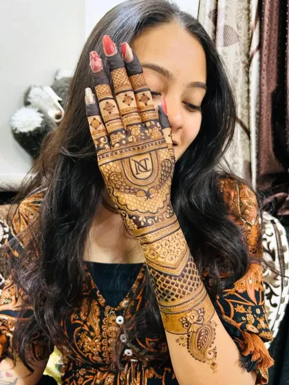 Another view of the monogram mehandi, showing how the design looks from a different angle. The fine lacework patterns on the wrist complement the bold initials.