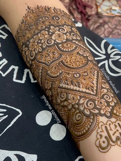 Another view of the personalized bridal henna for Tasmiya, with the groom's name beautifully placed on her forearm.