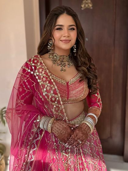 A front view of the bride with the voluminous half-up style, showing how it frames her face.