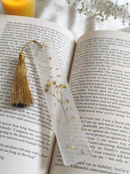 A close-up of one of my custom bookmarks. I used a sprig of baby's breath and gold flakes set in clear resin, with a golden tassel to finish it off. It's a lovely way to mark your page.