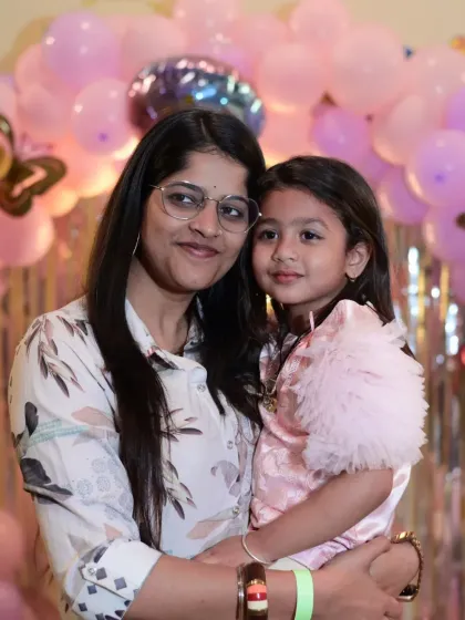 A mother and daughter sharing a hug in front of the birthday backdrop. These are the tender moments to cherish.
