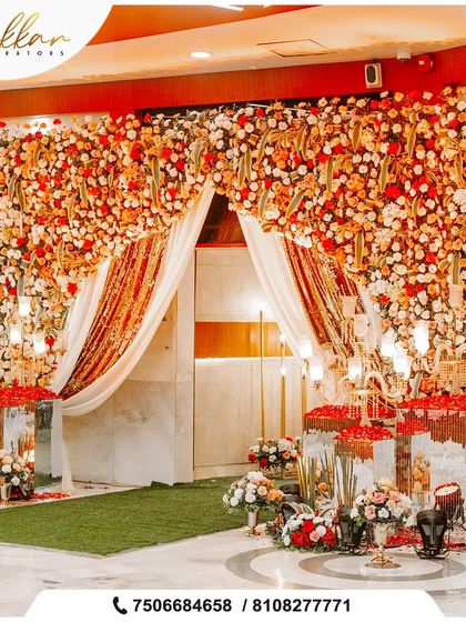 A dramatic entrance for a reception, with a curtain of red and white flowers and shimmering drapes. This is decor that makes you stop and say 'wow'.