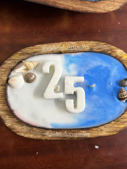 We can customize our beach-themed candles with numbers, making them perfect for birthdays or anniversaries. This one was for a 25th anniversary.
