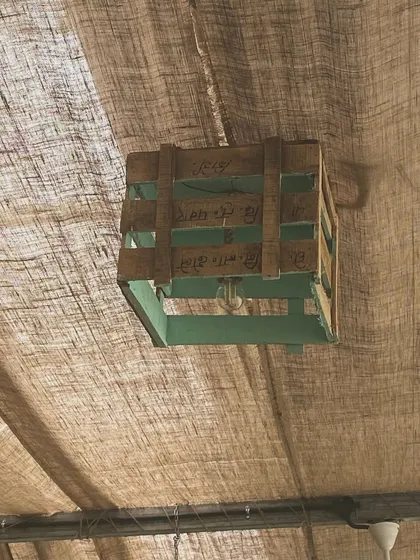 We believe in sustainability. This light fixture is made from a repurposed wooden crate, one of the many small details that contribute to our eco-friendly decor.