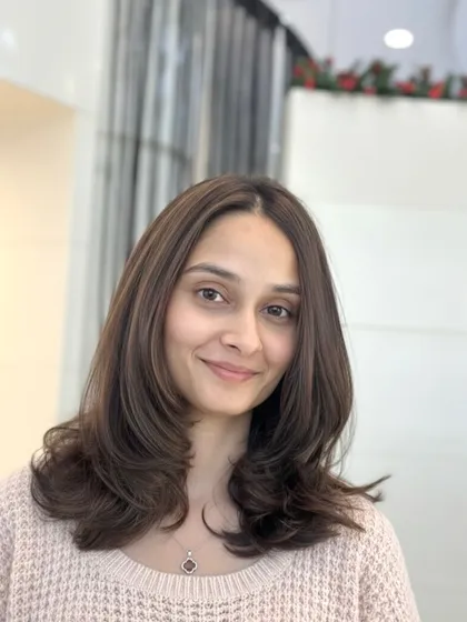 A portrait of the client with her soft melt brown hair. The color is natural-looking and enhances her features beautifully.