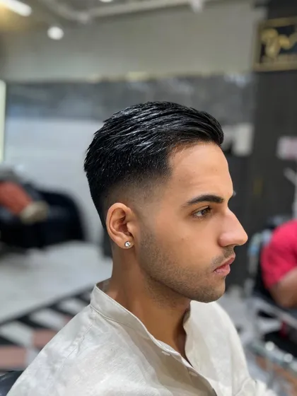 Success favors the well-groomed. This client is looking sharp and ready for anything with his new slicked-back fade.