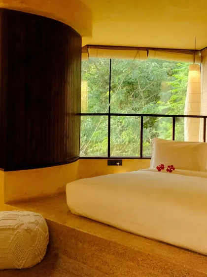 A suite designed for ultimate relaxation, with a sunken bed and a curved wall that leads to the bathroom, creating a soft, flowing space.