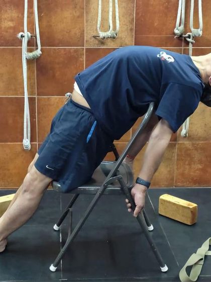 A supported backbend on a chair.