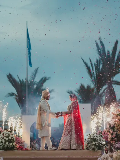 A beautiful varmala moment with pyrotechnics. We show up, fully, for every wedding, because we believe in the magic of these heartfelt celebrations.