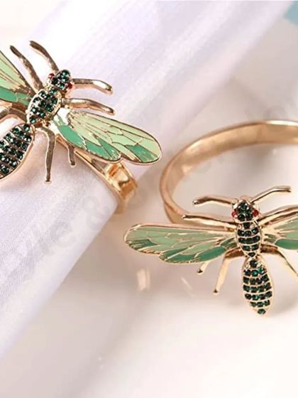 This bee-themed napkin ring is a unique and whimsical accessory. The detailed green enamel and sparkling accents make it a standout piece that adds a touch of nature-inspired charm to your dining decor.