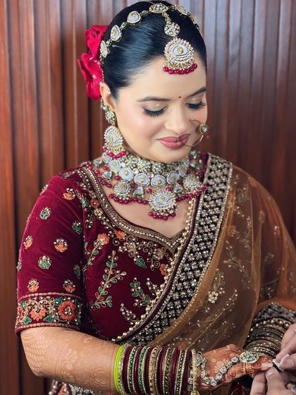 A side profile showing the beautiful floral hair bun and the perfectly blended makeup.