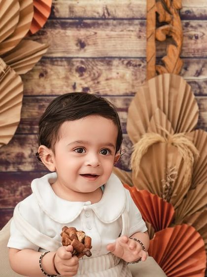 A handsome little gentleman. This close-up portrait captures the sweet and curious expression of a baby during his sitter session.