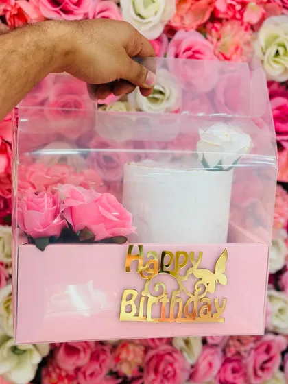 This is my signature birthday hamper, designed to make gifting simple and special. It features a half-kg tall cake, fresh flowers, and a golden 'Happy Birthday' topper, all beautifully packaged.