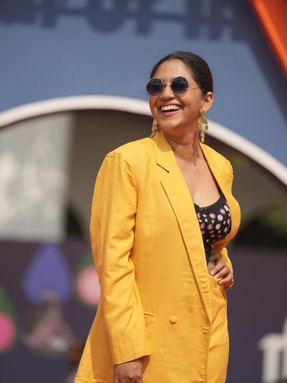 A joyful, laughing shot of Mrunmayee Deshpande on the red carpet, showing how confidence and great style go hand in hand.