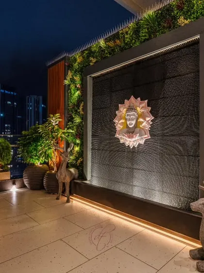 Another view of the Buddha water wall, showcasing the beautiful texture of the wall and the soft glow of the ambient lighting. This is a perfect spot for evening meditation or relaxation.
