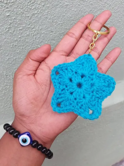 This blue star-shaped keychain is a simple and charming accessory. I can make these in any color to match your style or favorite sports team.