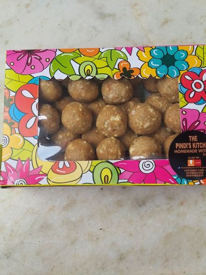 My homemade Atta Pinni Laddoos, neatly packed and ready for you to take home. These immunity-boosting sweets are loaded with dry fruits and made with pure ghee, making them a healthy and delicious snack.