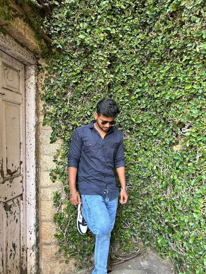 A candid shot against the rustic, ivy-covered walls of the palace.