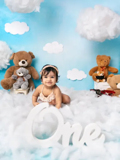 Up in the clouds for his first birthday! This dreamy theme features soft cotton clouds, teddy bears, and a big "One" sign to mark the special day.