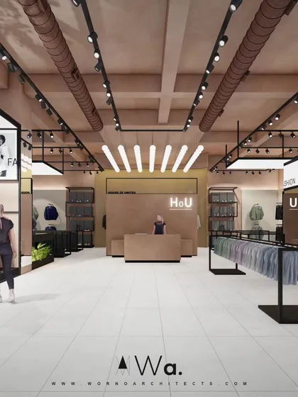 A front-facing view of the apparel store's reception desk, showing the cohesive design language. The industrial ceiling with exposed ducts and track lighting contrasts with the warm, lime-plastered walls and minimalist branding.