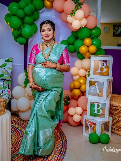 A beautiful portrait of the expecting mother next to the "BABY" blocks, a classic and adorable prop for any baby shower.