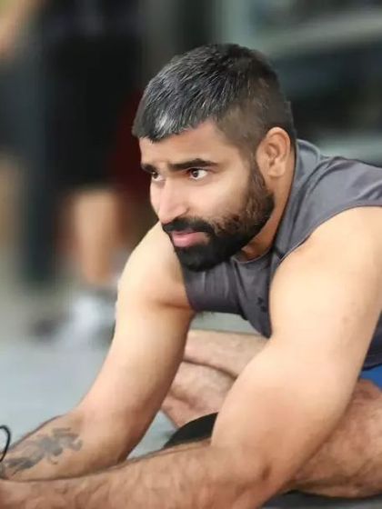 A deep hamstring stretch, known in yoga as Janu Sirsasana or Head-to-Knee Pose. Maintaining flexibility in the hamstrings is crucial for lower back health and overall mobility.