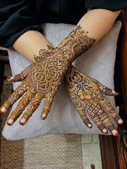 A crossed-hands pose showing a stunning floral design. The large rose on the back of the hand is a beautiful focal point.