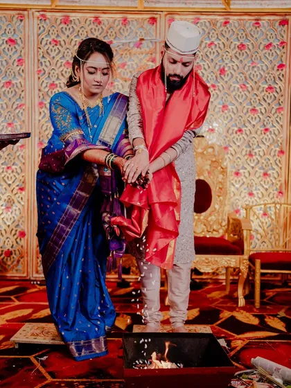 The couple participating in the sacred wedding rituals together.