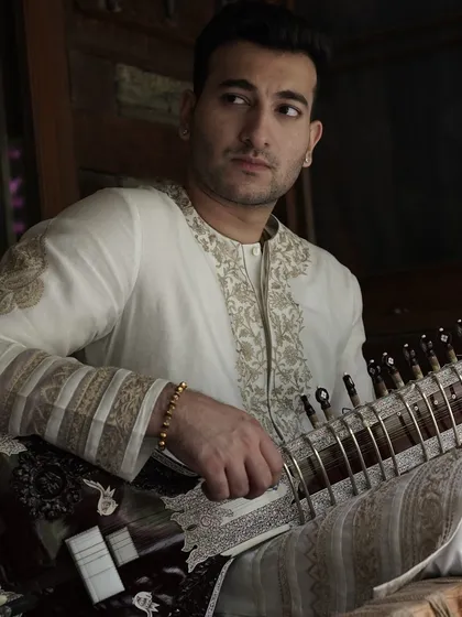 A quiet, contemplative portrait. The intricate embroidery on the white kurta adds a touch of elegance.