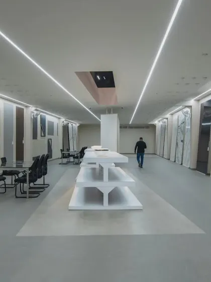 More images from the Krsimar marble showroom, detailing the sliding panel display system and the clean, spacious layout designed for an optimal client experience.