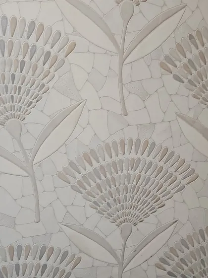 An intricate floral mosaic tile. The delicate pattern is created with small, individually placed stone pieces, offering a subtle and sophisticated texture.