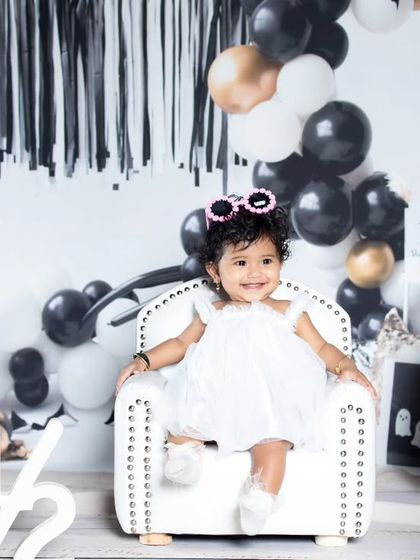 This little rockstar is celebrating her half-birthday in style, with cool sunglasses and a mini armchair.