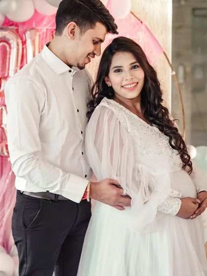 This white flare gown is perfect for a baby shower or an angelic maternity shoot. It features a sequined bodice and dramatic long balloon sleeves for a touch of whimsy.