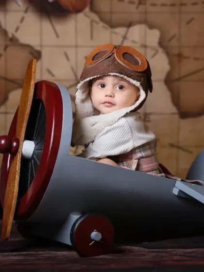 Ready for takeoff! Our studio is filled with imaginative props to bring any theme to life. This vintage pilot setup is a favorite for capturing the adventurous spirit of your little explorer.