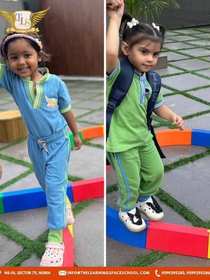 Two children confidently navigate the balance beam. Activities like this build physical confidence and gross motor skills in our little learners.