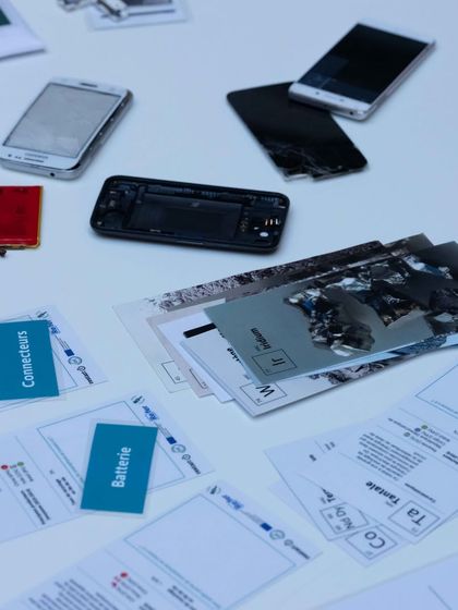 A collection of disassembled mobile phones and components laid out for a workshop. This hands on exploration helps kids understand the internal workings of the gadgets they use every day, from batteries to connectors.
