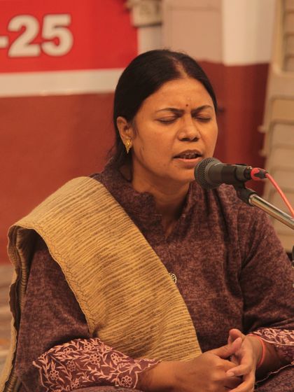 The deep concentration of a student during her bhajan recital.