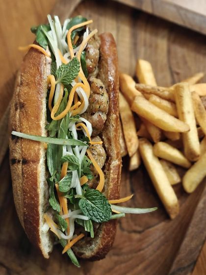 A rustic shot of our Bánh Mì with fries, a popular choice from one of our past brunch menus.