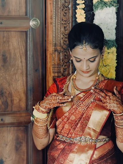 A close-up of the bride's hands, showing her intricate mehndi and the details of her jewelry. I always consider the entire look, from head to toe.