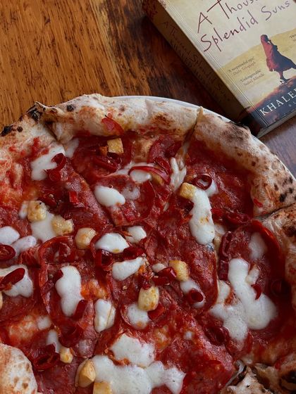 Another shot of our spicy pepperoni pizza with a good book. It's a recurring theme for a reason.