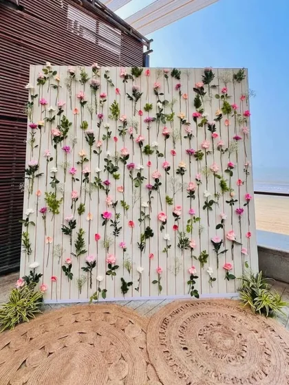 Sometimes, simplicity is the ultimate elegance. This beautiful floral photo wall was designed for a beachside event, with individual stems of pink and white roses creating a delicate and romantic backdrop against the ocean view.