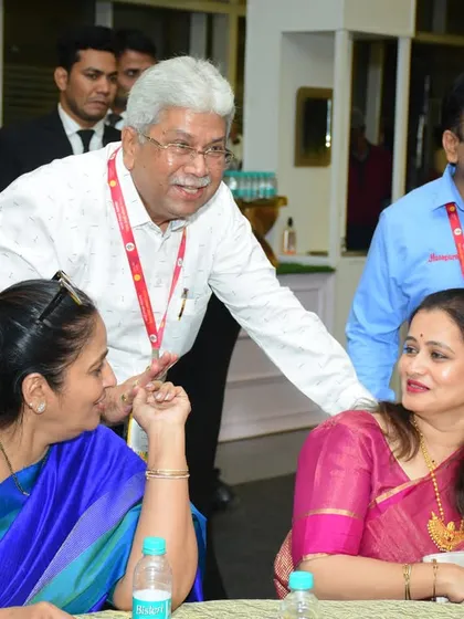 Interacting with guests at the Vishwa Marathi Sammelan. I make it a point to be personally present at our events to ensure everything is perfect.