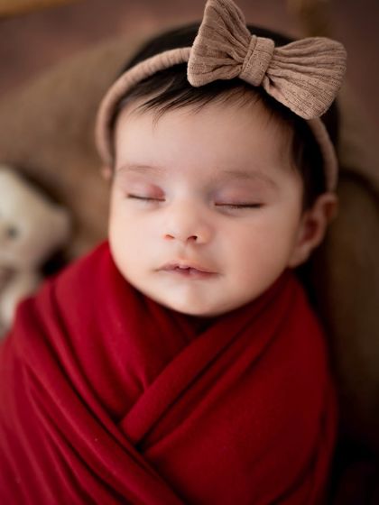 A close-up on a sleeping angel. This shot focuses on the peaceful expression and perfect features of a newborn baby.