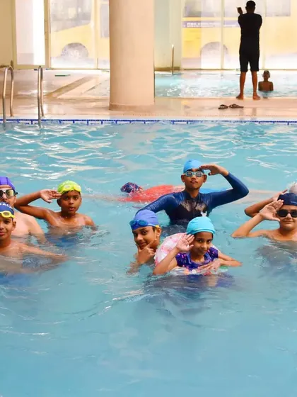 A happy and energetic group of young swimmers ready for their lesson. We create a positive environment where kids feel motivated.